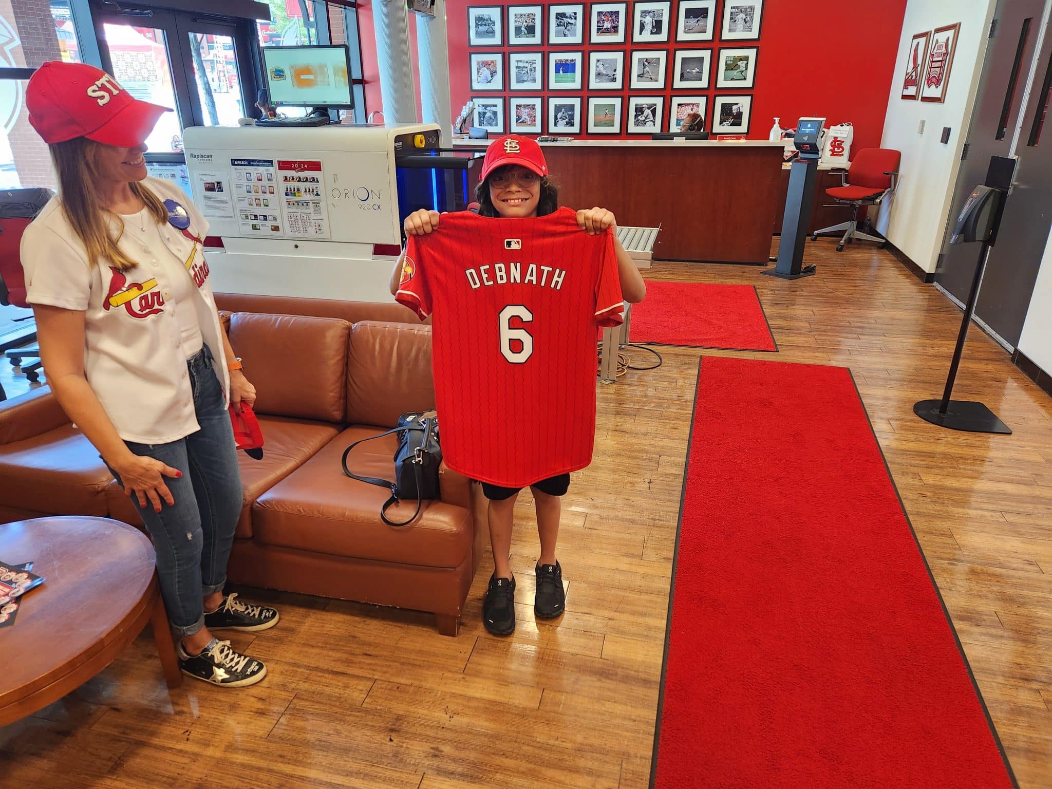 Wish kid Sidney holding up his custom jersey from the St. Louis Cardinals