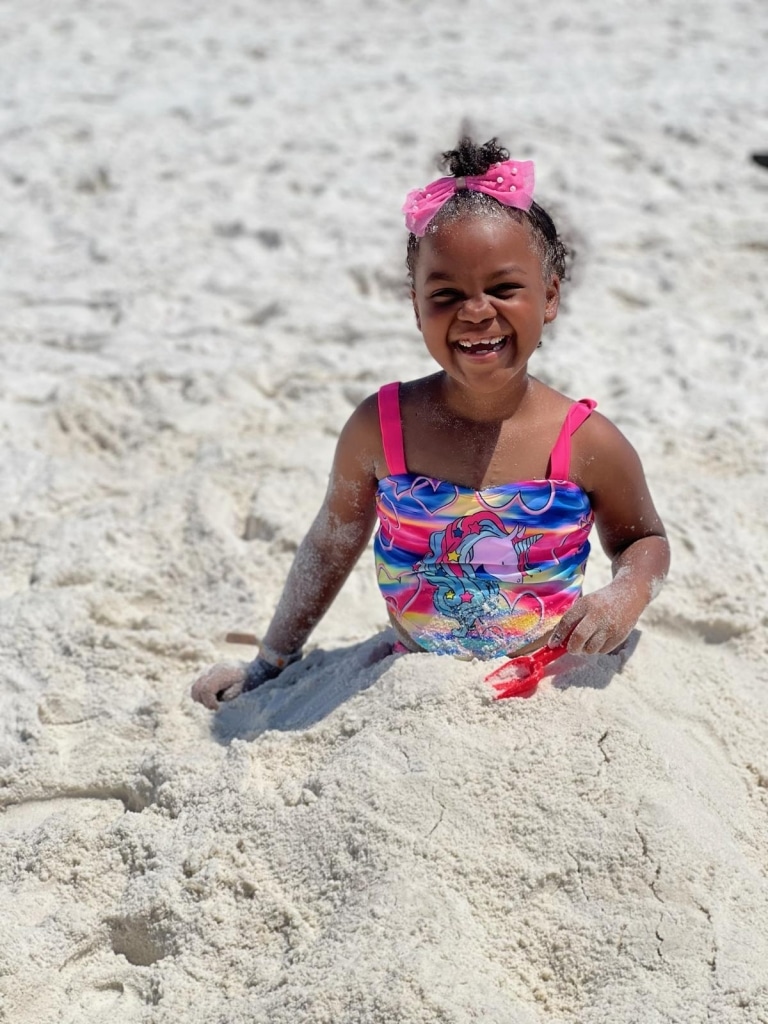 Imani plays in the sand during her beach trip