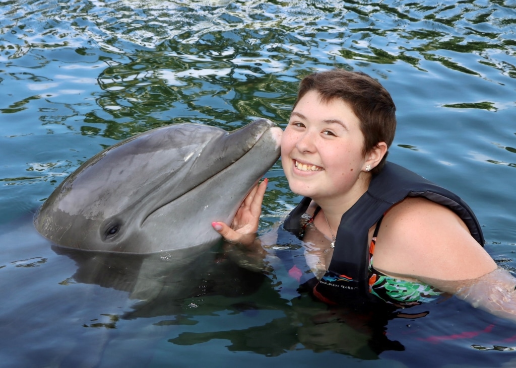 Wish Kid Avery getting kissed by a dolphin