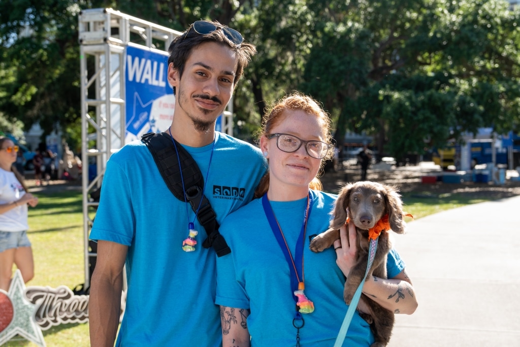 Volunteers holding a dog at the Walk For Wishes
